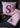 A pink Liberty floral fabric baby blanket with a matching cushion personalised with a pink glitter letter.