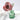 A rose made from red Liberty fabric with white flowers in a green glass bottle in