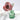 A rose made from red Liberty fabric with white flowers in a green glass bottle in