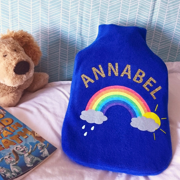 Rainbow hot water bottle cover with name. Royal blue fleece.