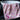 A pink floral new baby blanket draped over a white basket - great gift for new baby