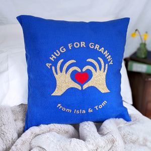 Royal blue fleece cushion with gold glitter hands forming heart. Personalised gift for granny