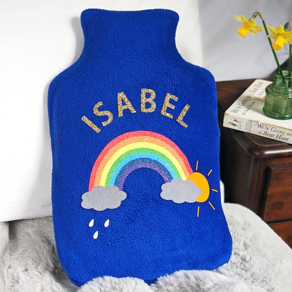 Royal blue hot water bottle cover with glittery rainbow, personalised with gold glitter name