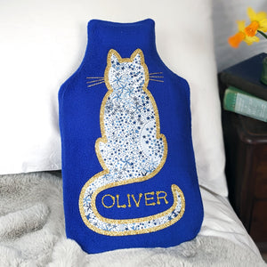 Personalised royal blue fleece hot water bottle cover with Liberty fabric cat and gold glitter.